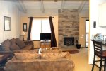 Mammoth Lakes Rental Sunshine Village 106 - Open Area Living Room has a woodstove